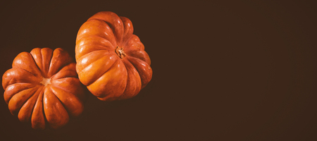 Close up of pumpkins against black background during Halloween