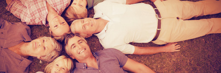 Happy family lying on field