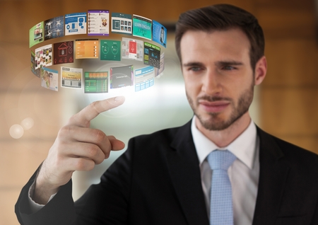 Digital composite of Screen interface and Businessman touching air in front of elevatorの写真素材