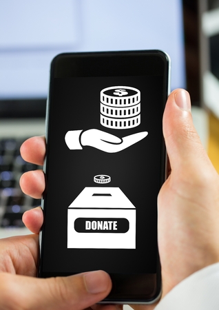 Digital composite of Hand using phone with donate money box icons