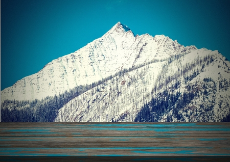 Digital composite of Wooden floor with snow mountain backgroundの写真素材