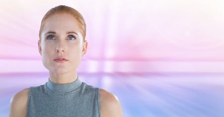 Digital composite of Woman looking up with soft motion background