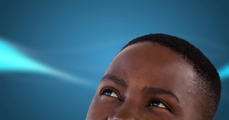 Digital composite of Man looking up with blue backgroundの写真素材