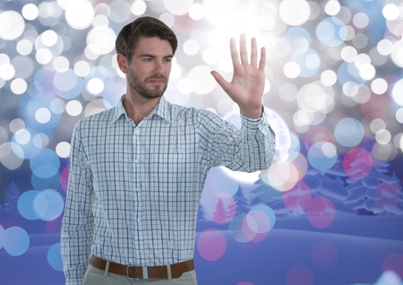 Digital composite of Businessman touching air with open hand in front of sparkling lightsの写真素材