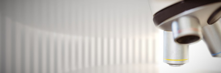 Microscope  against white curved room with bright light