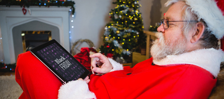 Black friday advert against santa claus using digital tabletの写真素材