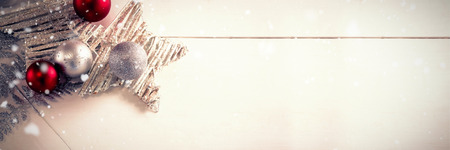 Snow falling against overhead view of christmas decoration on tableの写真素材