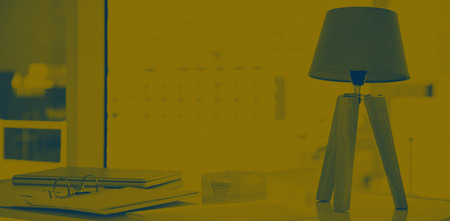 A desk with lamp and documents at workの写真素材