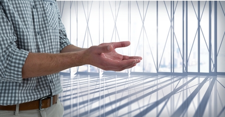 Digital composite of Businessman with hands palm open in city office