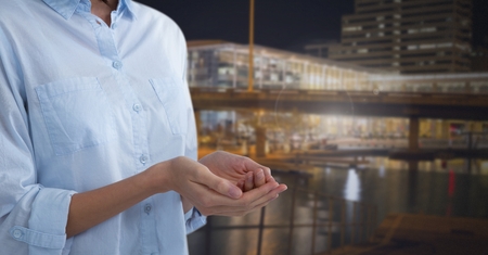 Digital composite of Business person with hands palm open in cityの写真素材