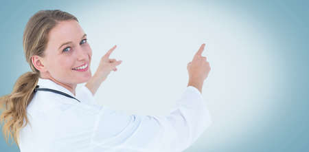 Young doctor pointing on white backgroundの写真素材