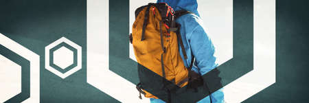 Rear view of skier standing with ski on snowy mountainsの写真素材