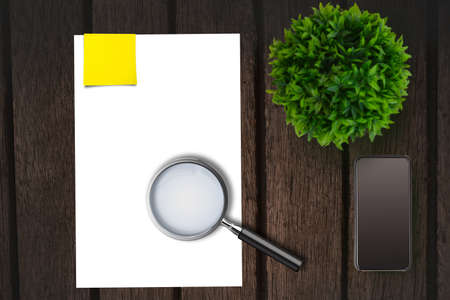 Magnifying glass on paper on the side of smartphone