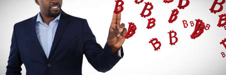 Businessman pressing an invisible virtual screen against several red bitcoin sign