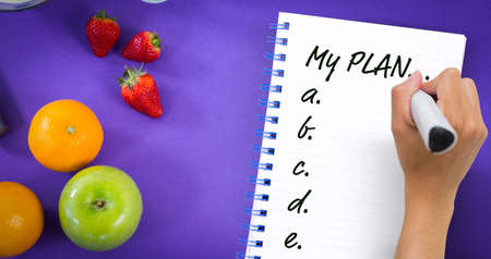 Hand writing with marker against overhead ciew of various fruits