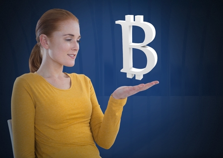 Digital composite of Bitcoin icon and Businesswoman with hands palm open and dark backgroundの写真素材