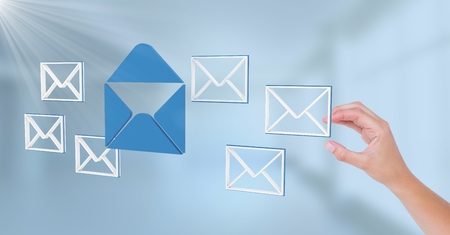 Digital composite of Hand touching 3D email message iconsの写真素材