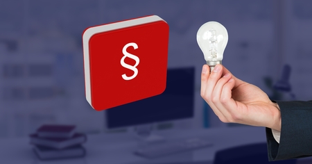 Digital composite of Hand holding light bulb and section symbol icon