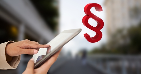 Digital composite of Hands holding tablet with section symbol iconの写真素材