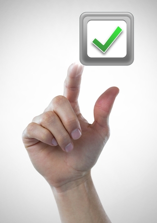 Digital composite of Hand touching correct tick boxの写真素材