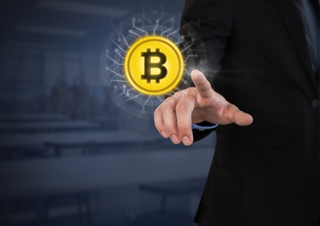 Digital composite of Businessperson touching bitcoin graphic iconの写真素材
