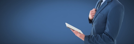 Digital composite of businessman holding tabletの写真素材