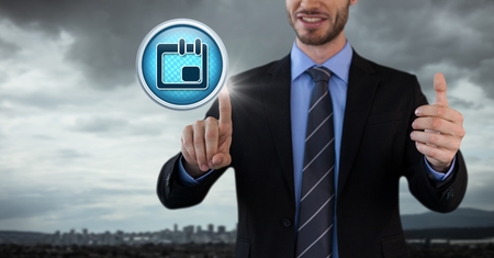 Digital composite of Planner calendar diary icon Businessman with hands touching air in city officeの写真素材