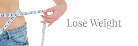 Digital composite of Lose weight text and woman measuring waistの写真素材