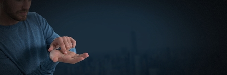 Digital composite of Businessman with hands palm open and dark backgroundの写真素材