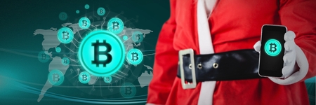 Digital composite of bitcoin icons and Christmas santa holding phoneの写真素材