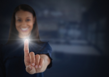 Digital composite of Businesswoman touching air glowの写真素材