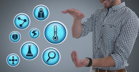 Digital composite of Scientific icons and Businessman with hands palm open in city