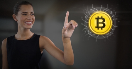Digital composite of Businesswoman touching bitcoin graphic iconの写真素材