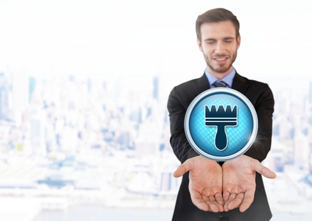 Digital composite of Clean brush icon and Businessman with hands palm open in cityの写真素材