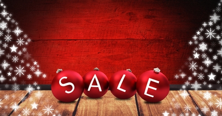 Digital composite of Sale Christmas baubles with wood and snowflake patternsの写真素材