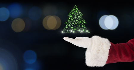 Digital composite of Santa holding Snowflake Christmas tree pattern shapeの写真素材