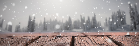 Snow falling against sun shining on mountain full of snow の写真素材