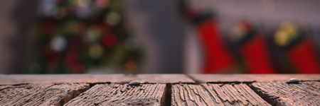 Rusty wooden plank against defocused of christmas tree lights and fireplaceの写真素材