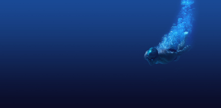 Man swimming in deep blue waterの写真素材