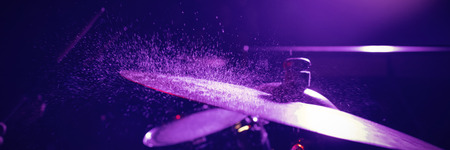 Close up of wet drum set in illuminated nightclubの写真素材