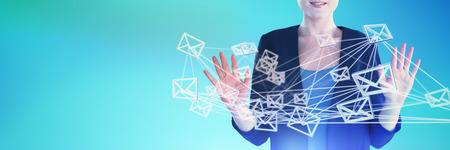 Mid section of smiling businesswoman gesturing against abstract blue backgroundの写真素材