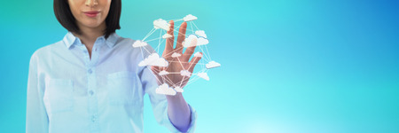 Woman using invisible screen against abstract blue backgroundの写真素材