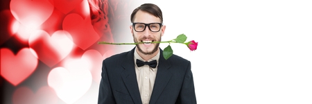 Digital composite of Valentines man biting rose with love hearts backgroundの写真素材