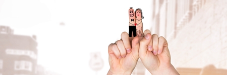 Digital composite of Valentine's fingers love couple and bright street backgroundの写真素材