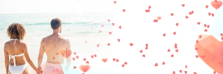 Digital composite of Couple by sea with valentine's love transition heartsの写真素材