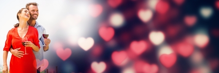 Digital composite of Couple with valentine's love transition hearts and wineの写真素材