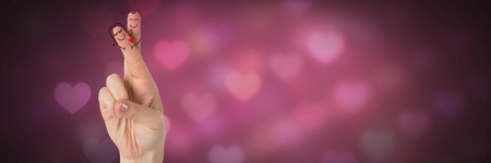 Digital composite of Valentine's fingers love couple and glowing colorful heart lightsの写真素材