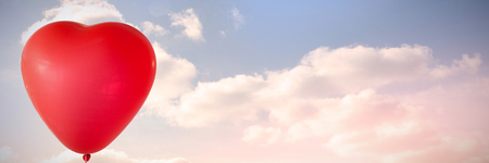 Valentines day heart balloon  against colored sky with cloudsの写真素材