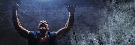 Digital composite of Strong Boxer man celebrating with blue light