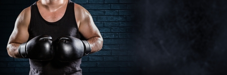 Digital composite of Boxer man with dark wallの写真素材